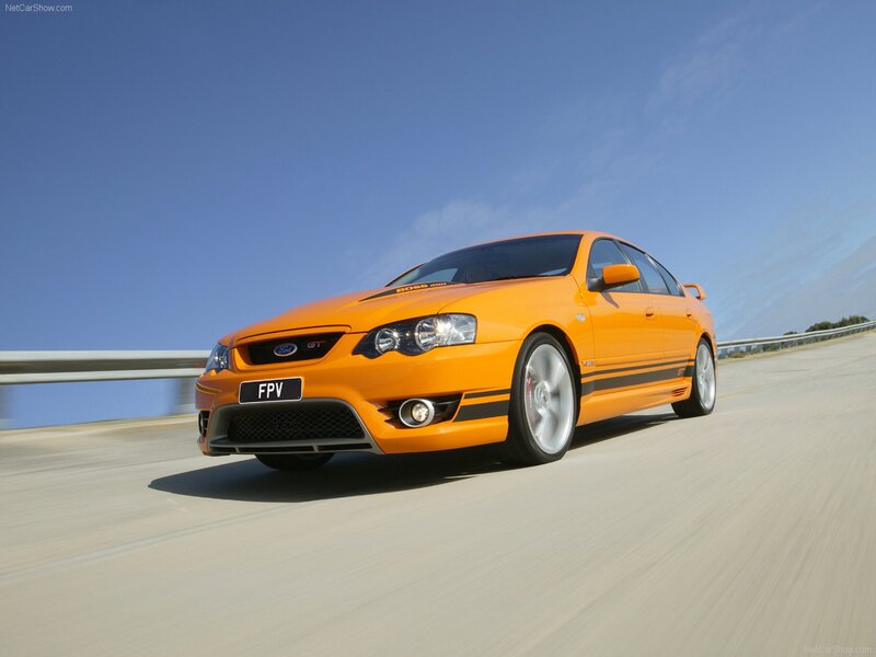 orange performance sedan on road