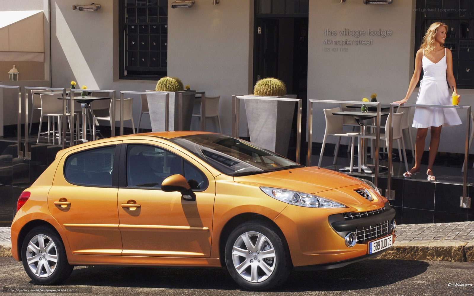 orange peugeot 207 parked outside