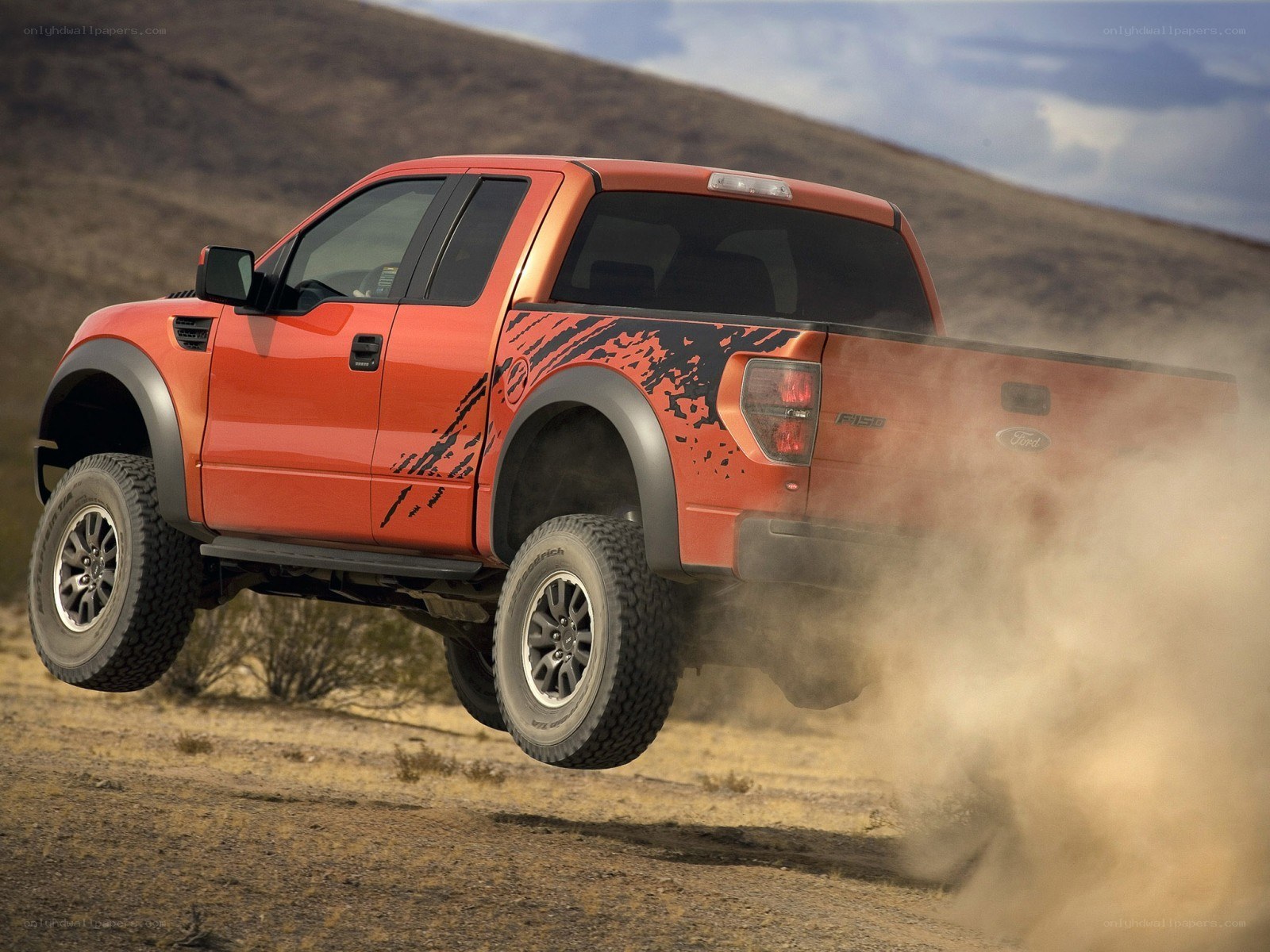 orange pickup truck in desert
