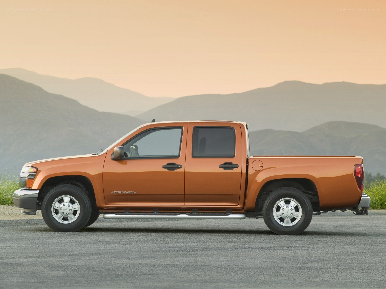 orange pickup truck in mountains