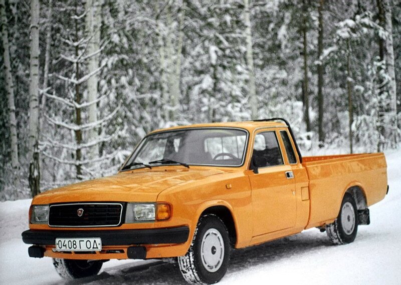 Orange pickup truck in snow