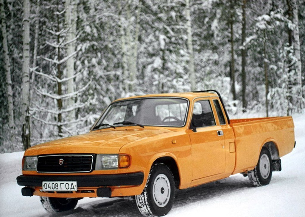 Orange pickup truck in snow