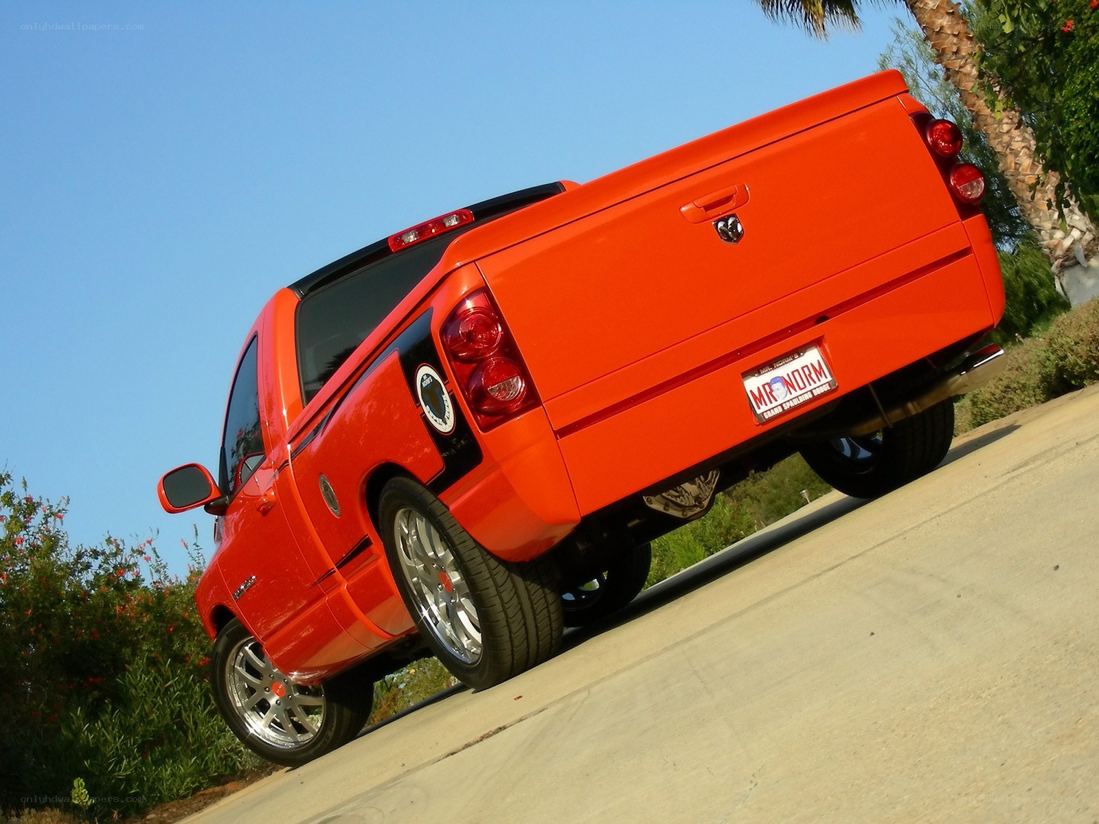 orange pickup truck on incline