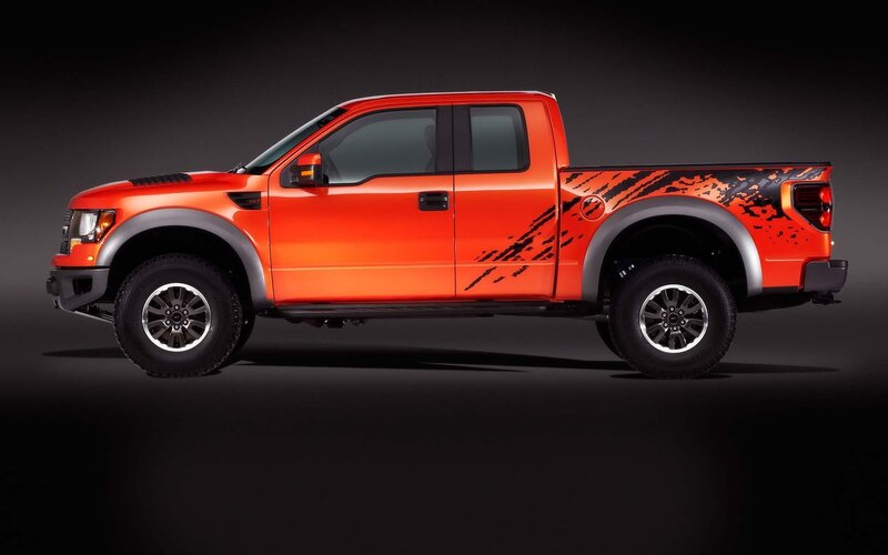 orange pickup truck with decals