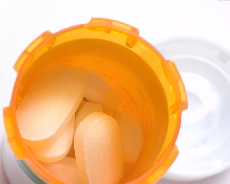 orange pill bottle with tablets