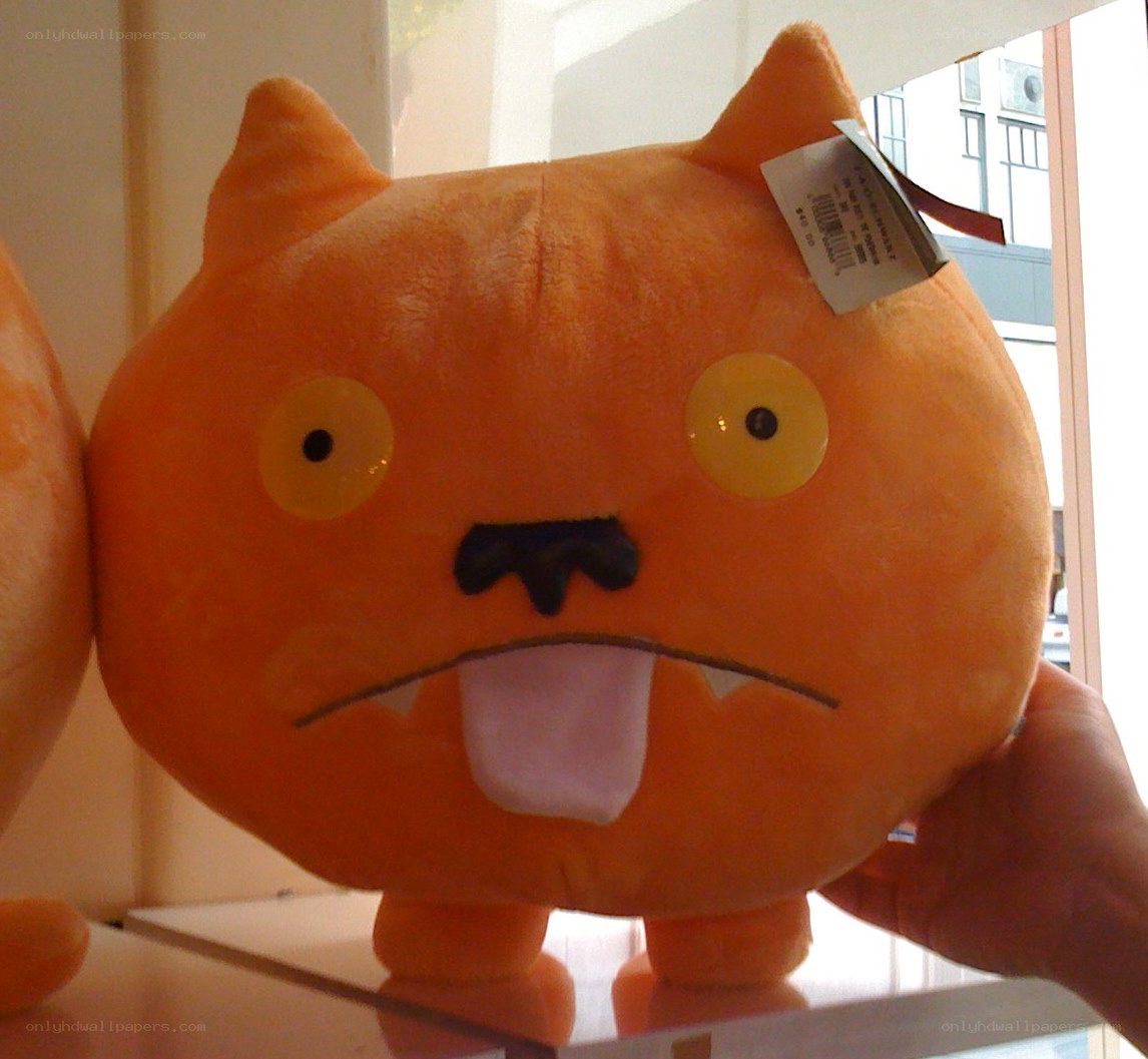 orange plush toy with tag