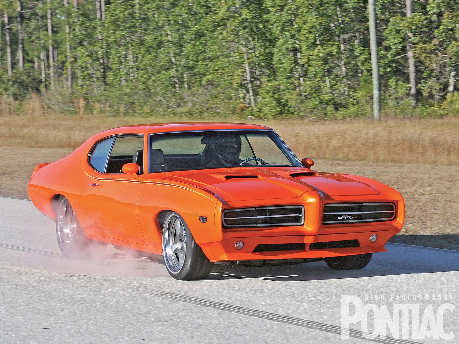 Orange Pontiac GTO on track