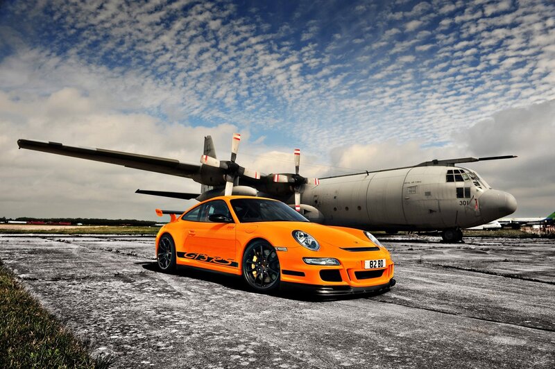 Orange Porsche and military plane