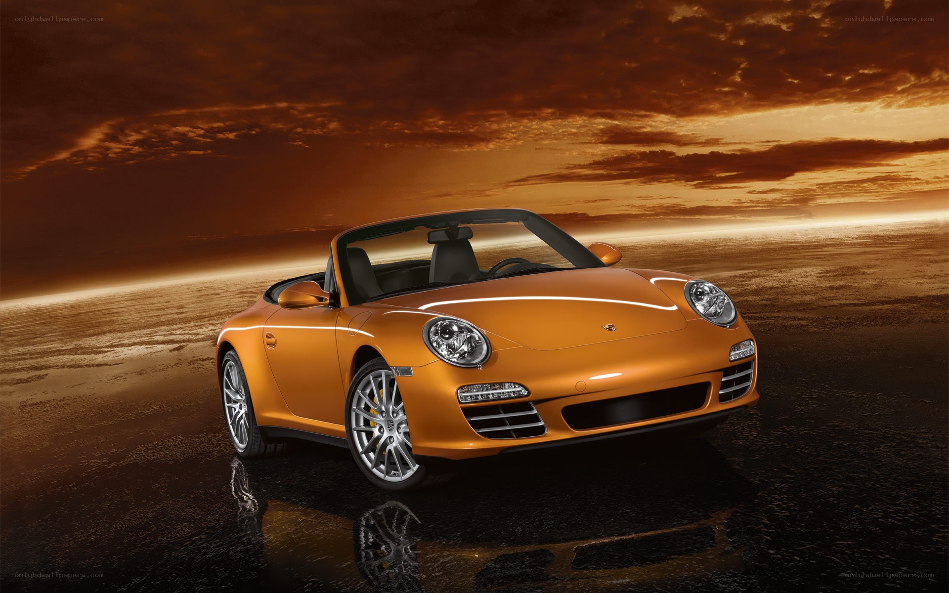Orange Porsche convertible at sunset