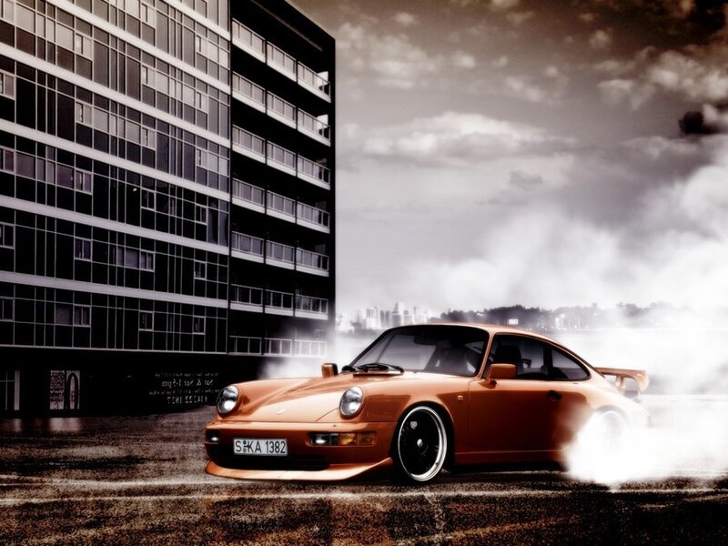 Orange Porsche drifting in city