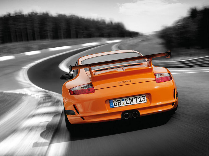 Orange Porsche GT3 RS on a racetrack