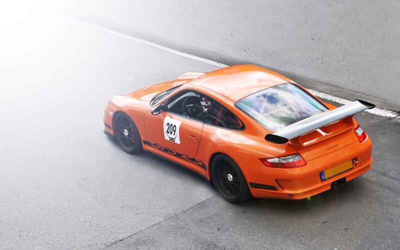 Orange Porsche GT3 RS on track