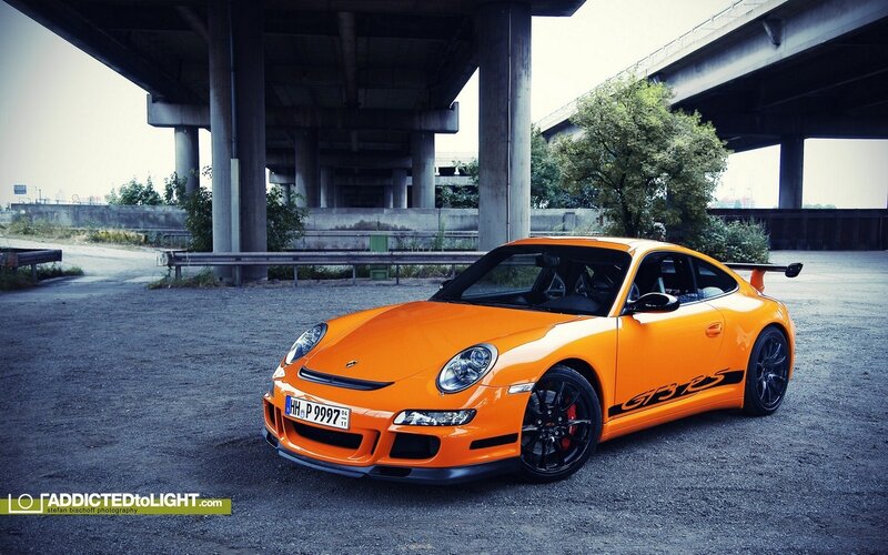 Orange Porsche GT3 RS under bridge