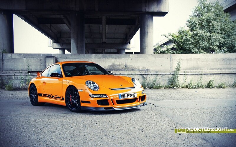 Orange Porsche GT3 RS under bridge
