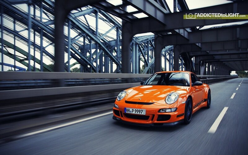 Orange Porsche on a bridge