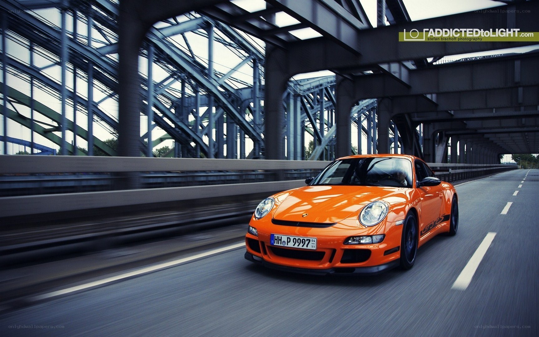 Orange Porsche on a bridge