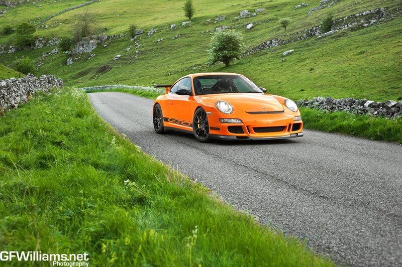 Orange Porsche on a country road