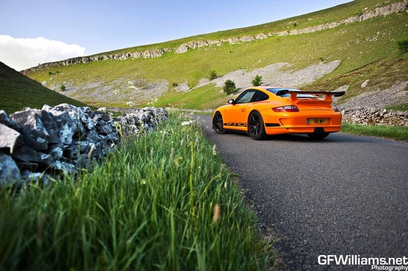 Orange Porsche on a country road
