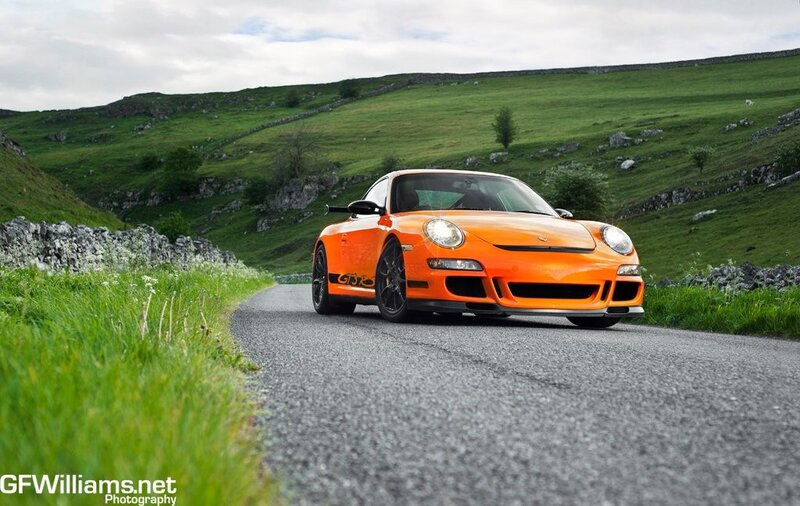 Orange Porsche on a country road