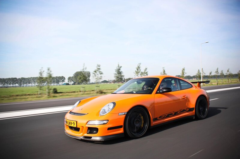Orange Porsche on a country road