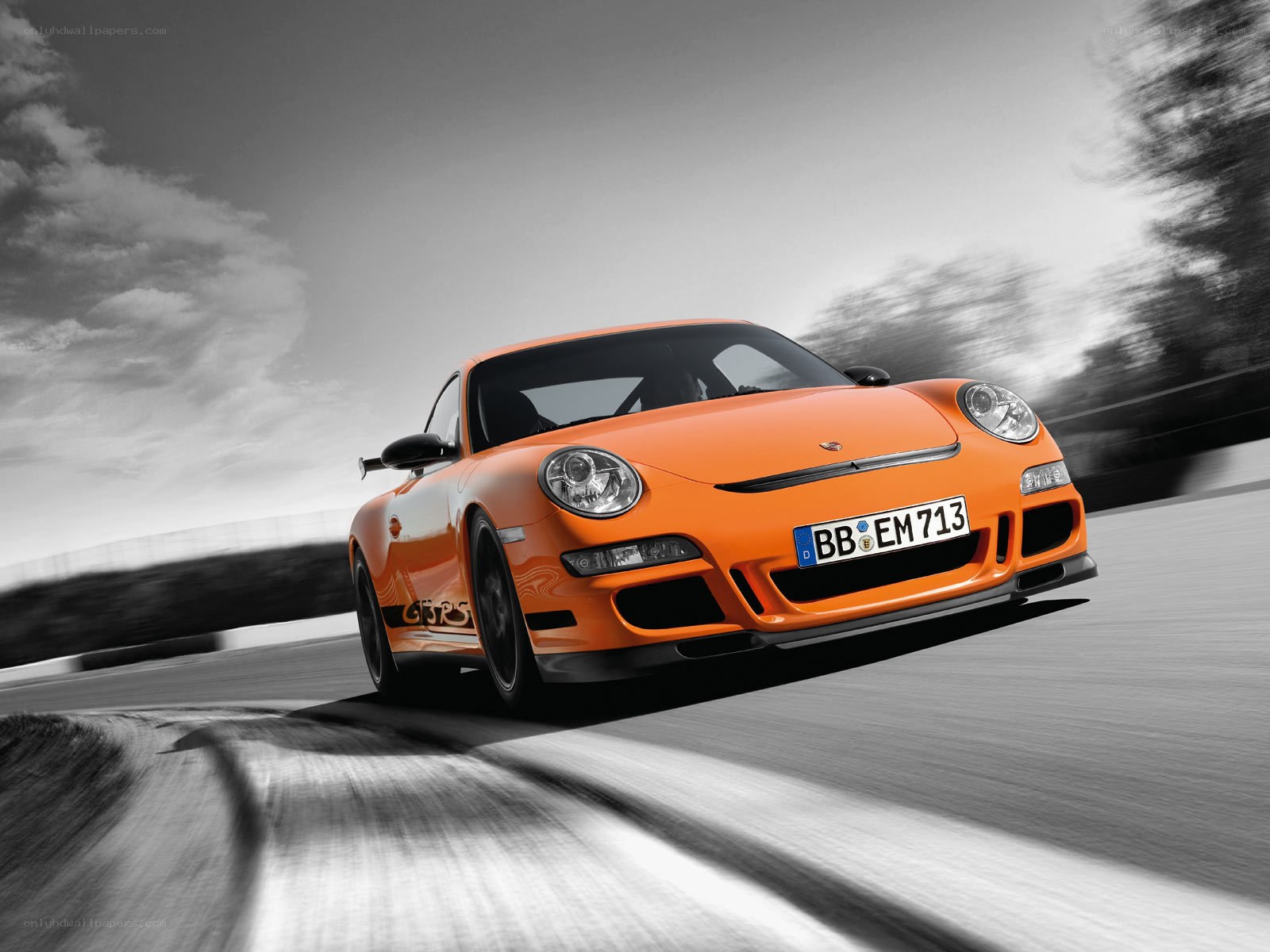 Orange Porsche on a racetrack