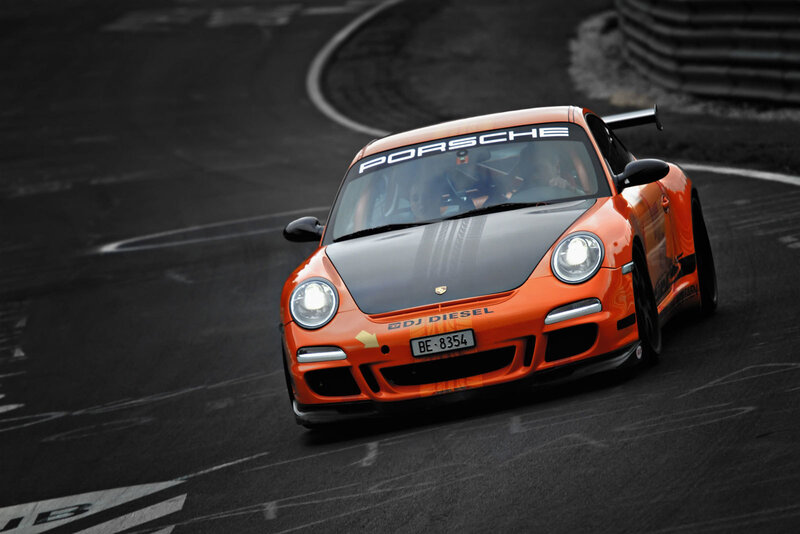 Orange Porsche on a racetrack