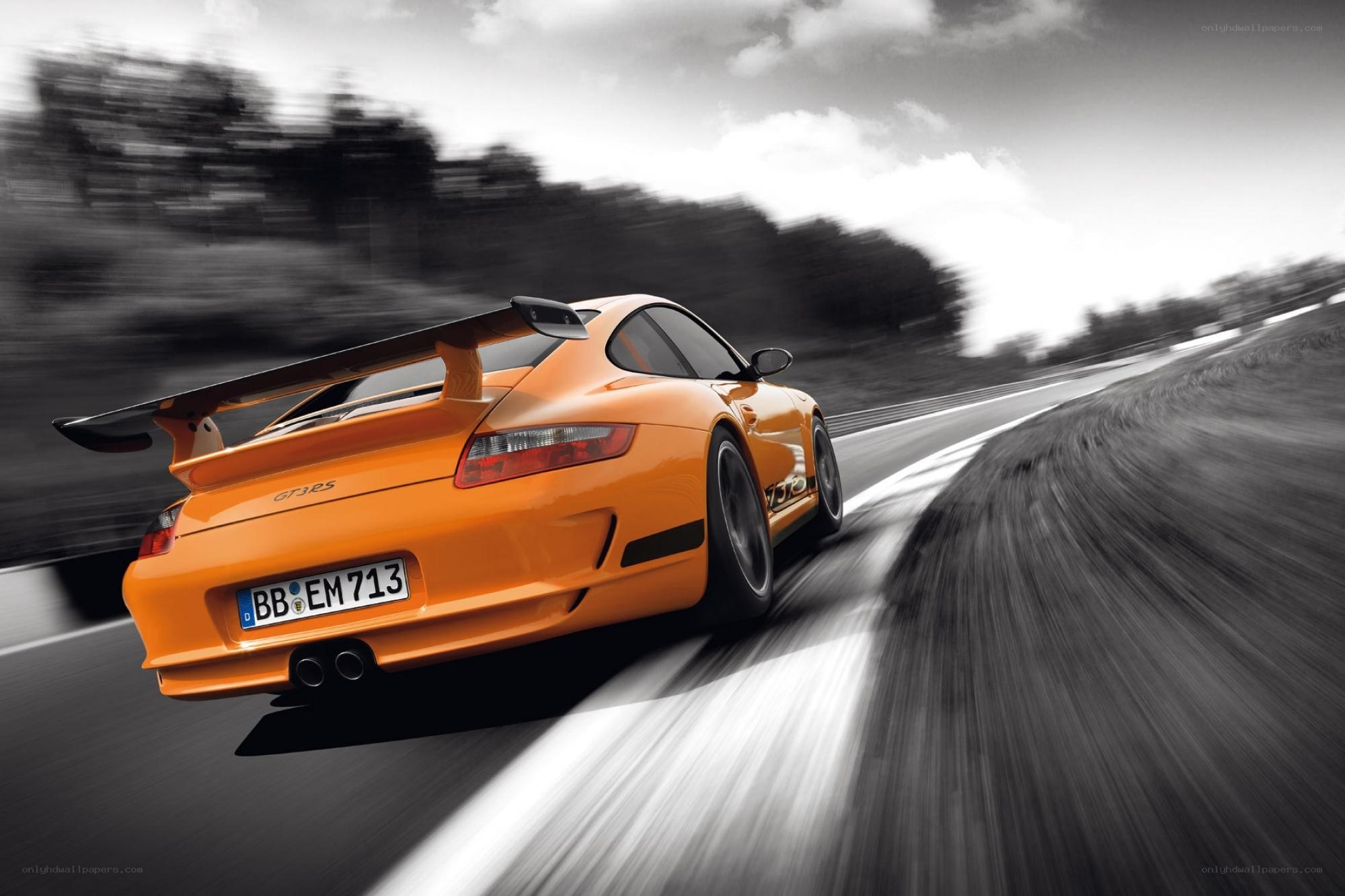 Orange Porsche on a racetrack