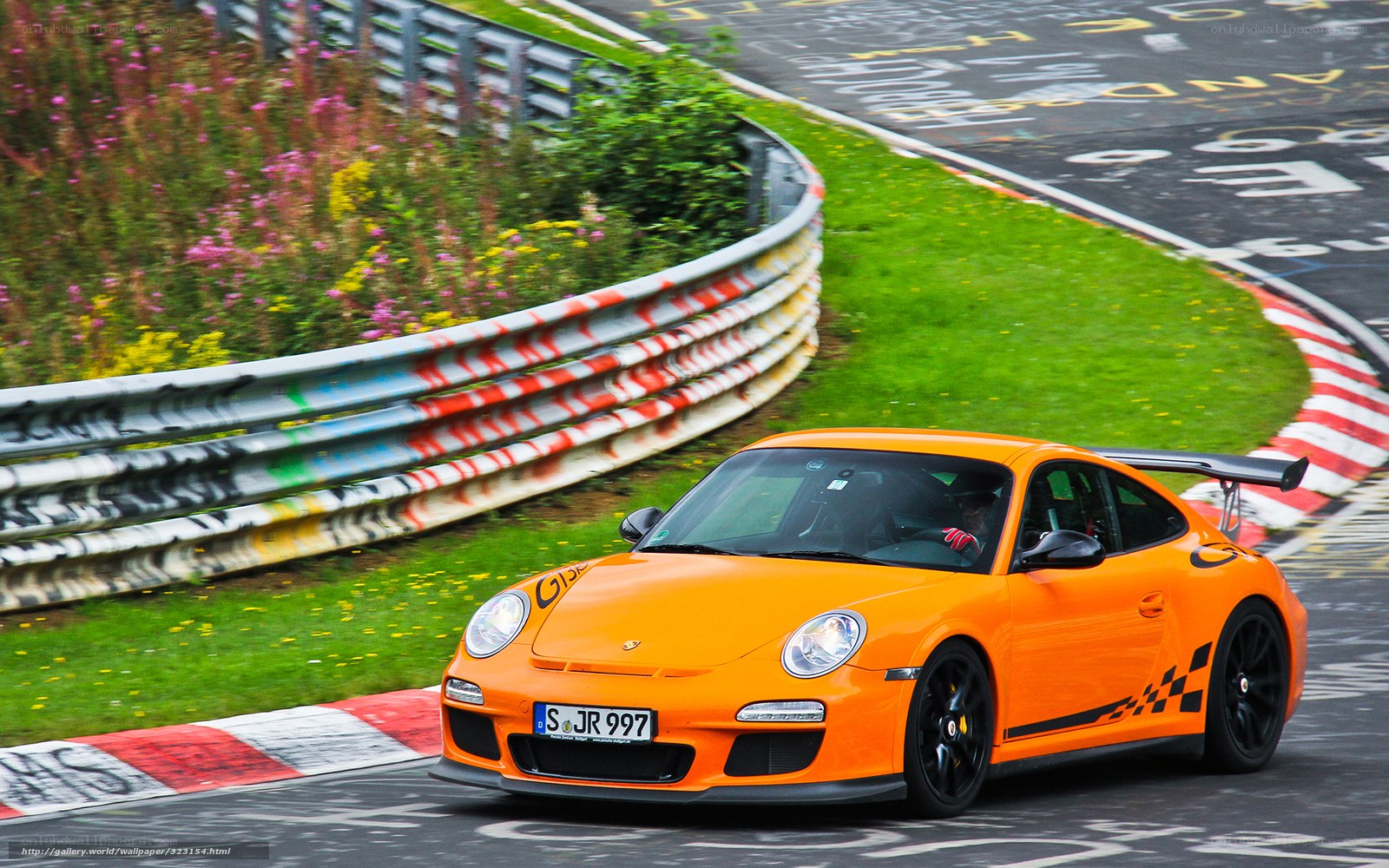 Orange Porsche on a racetrack