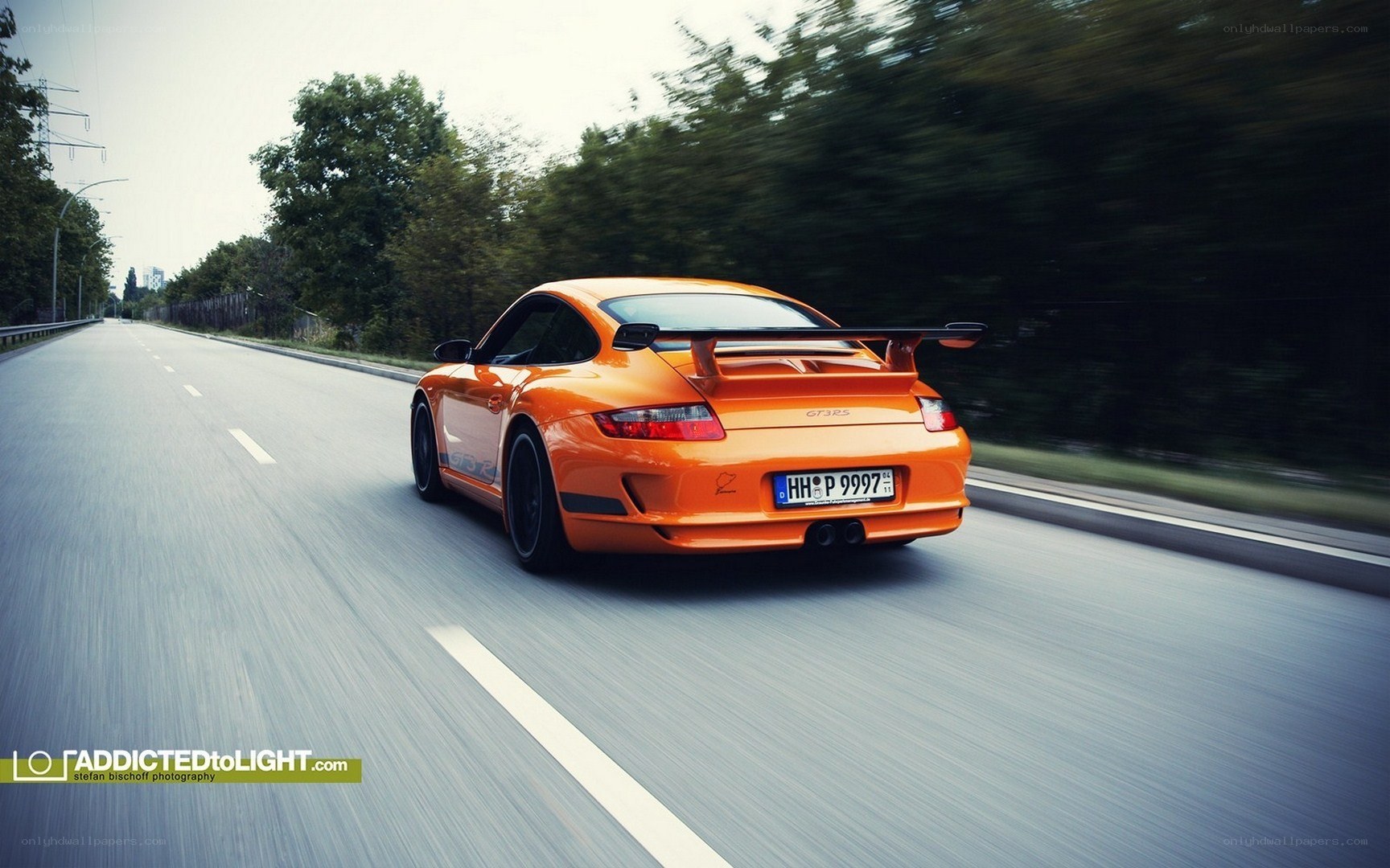 orange porsche on a road