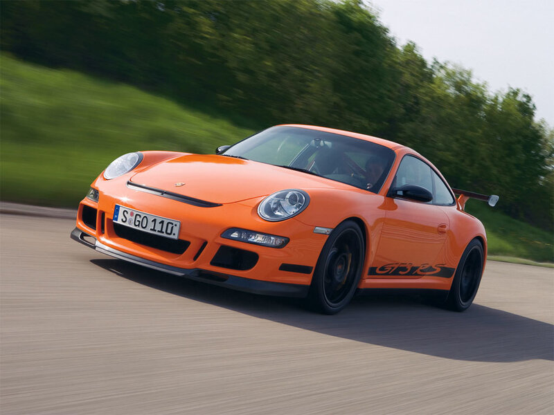 orange porsche on a road