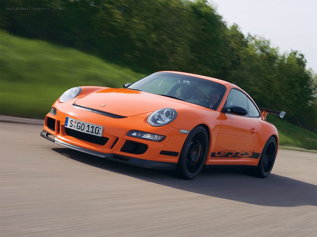 orange porsche on a road