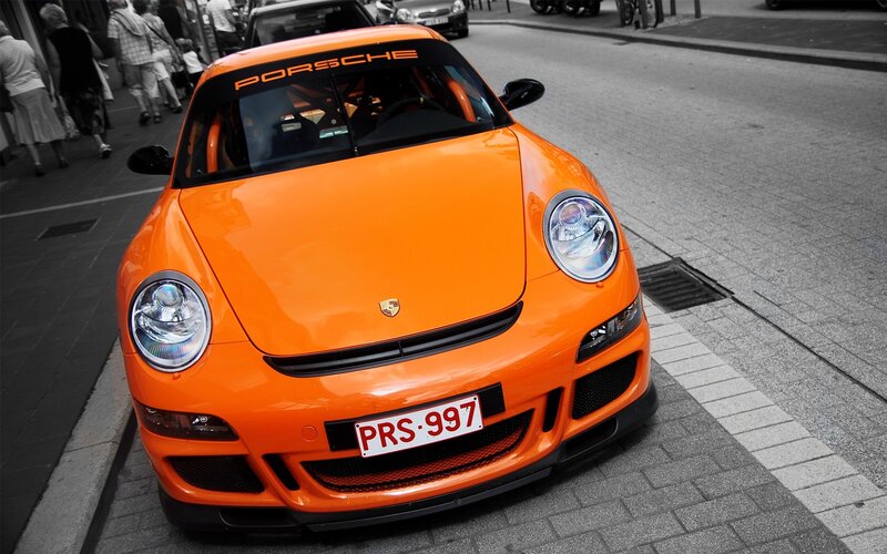Orange Porsche on city street