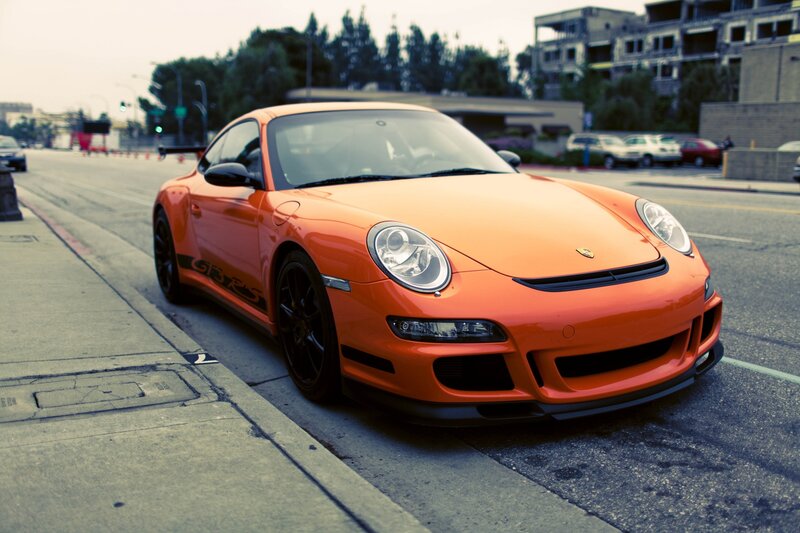 Orange Porsche on city street