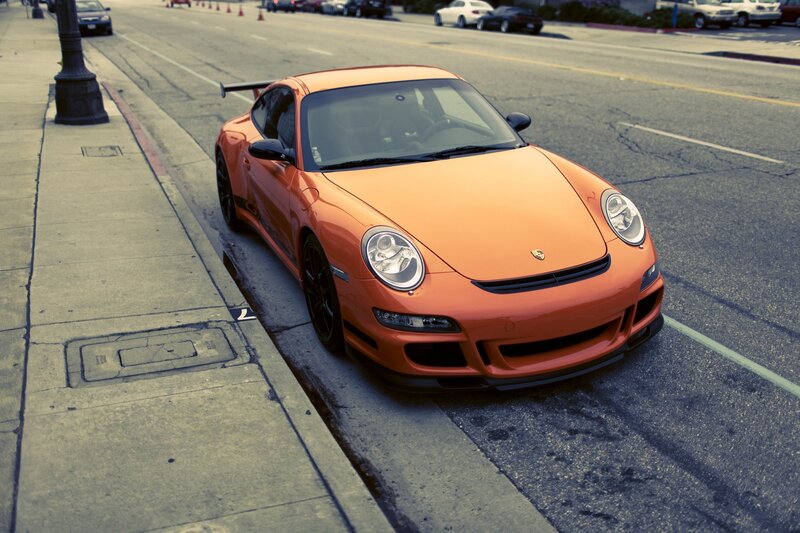 Orange Porsche on city street