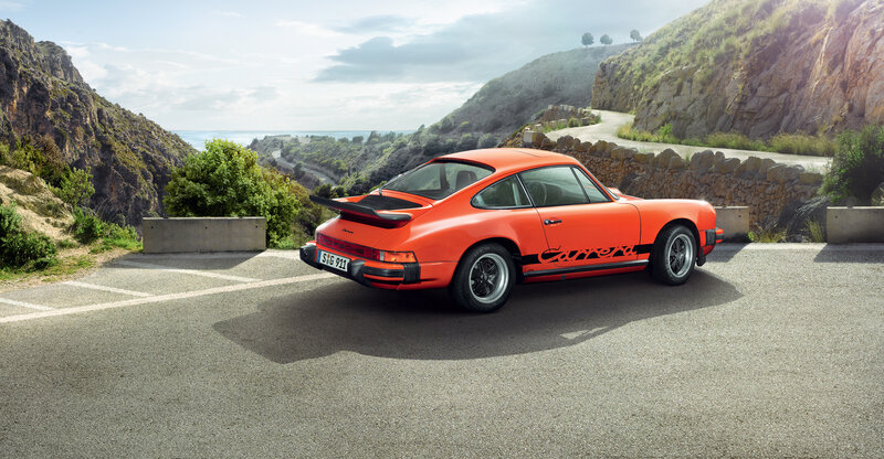 Orange Porsche on coastal road