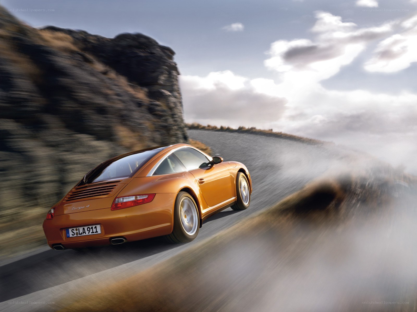 Orange Porsche on mountain road