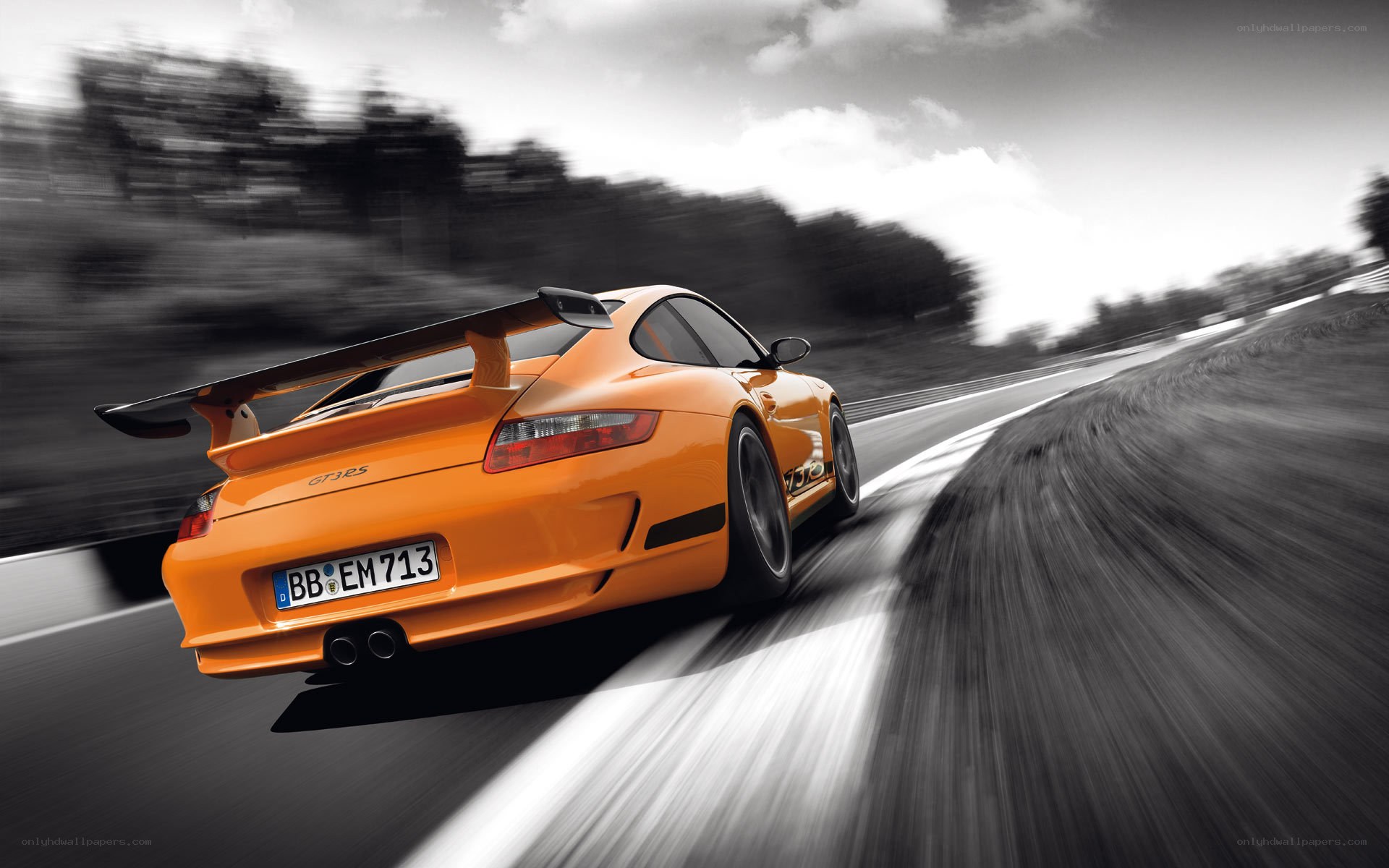 orange porsche on racetrack
