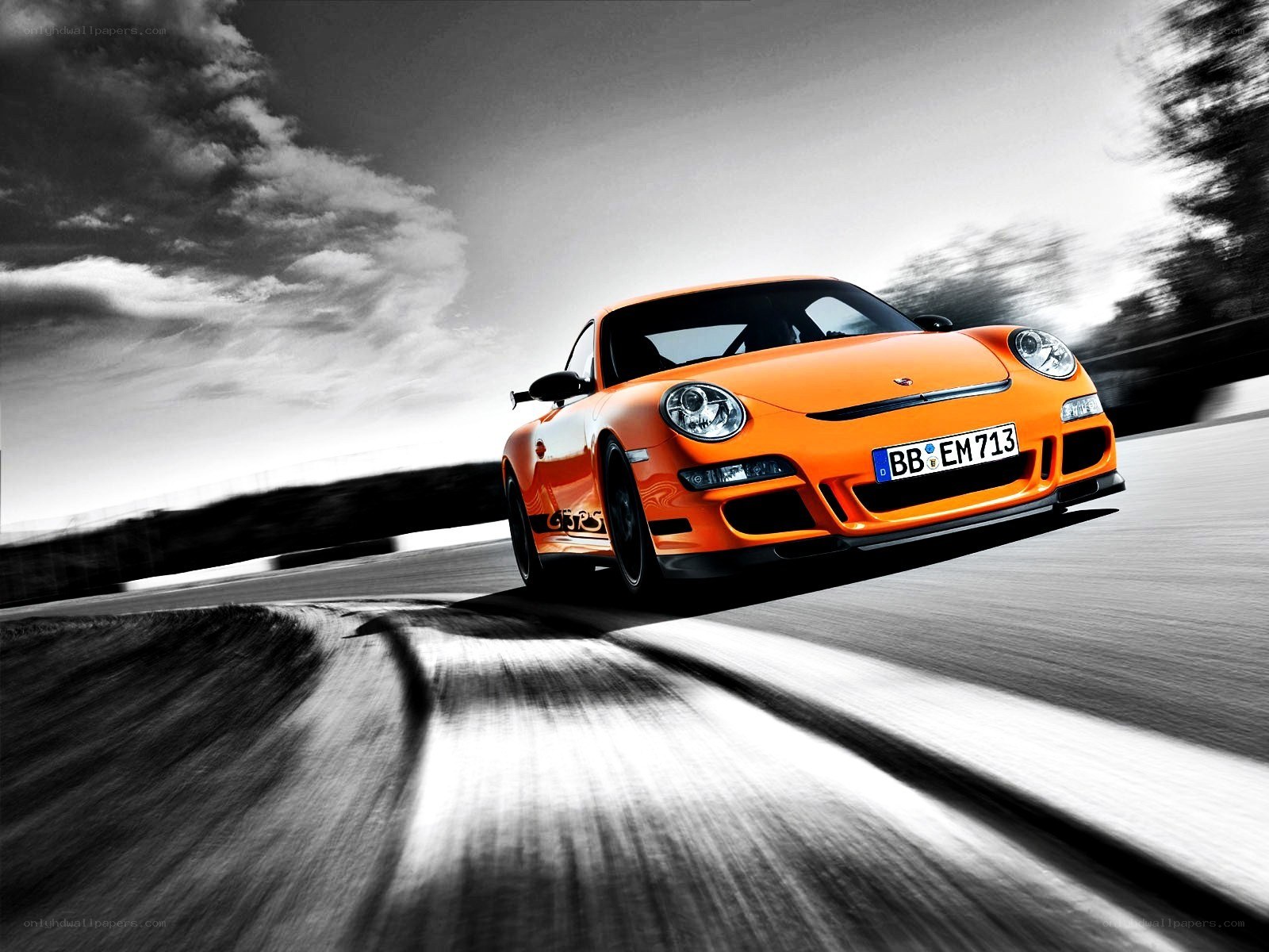 orange porsche on racetrack