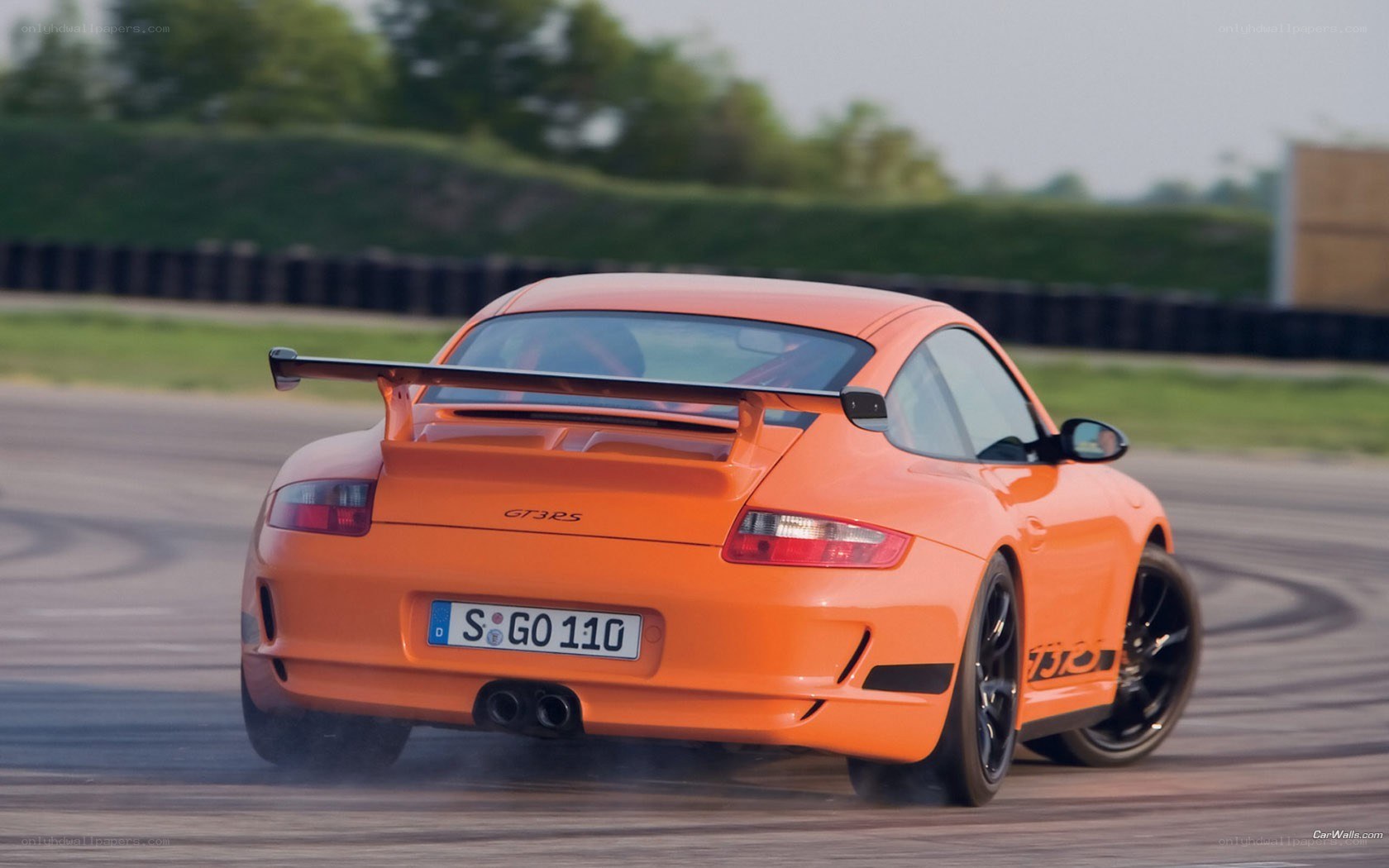 orange porsche on racetrack