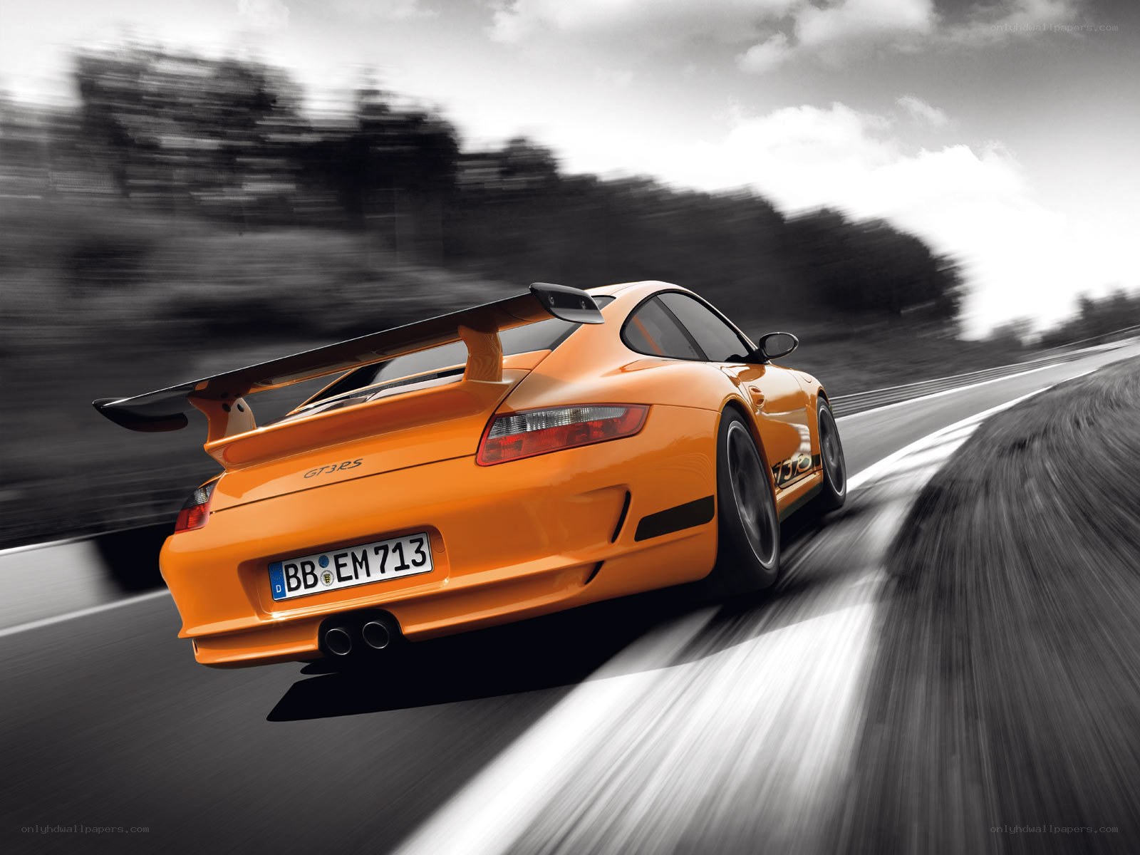 orange porsche on racetrack