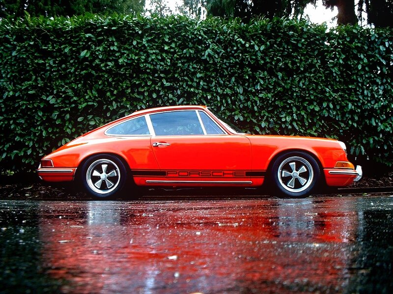 Orange Porsche on wet pavement