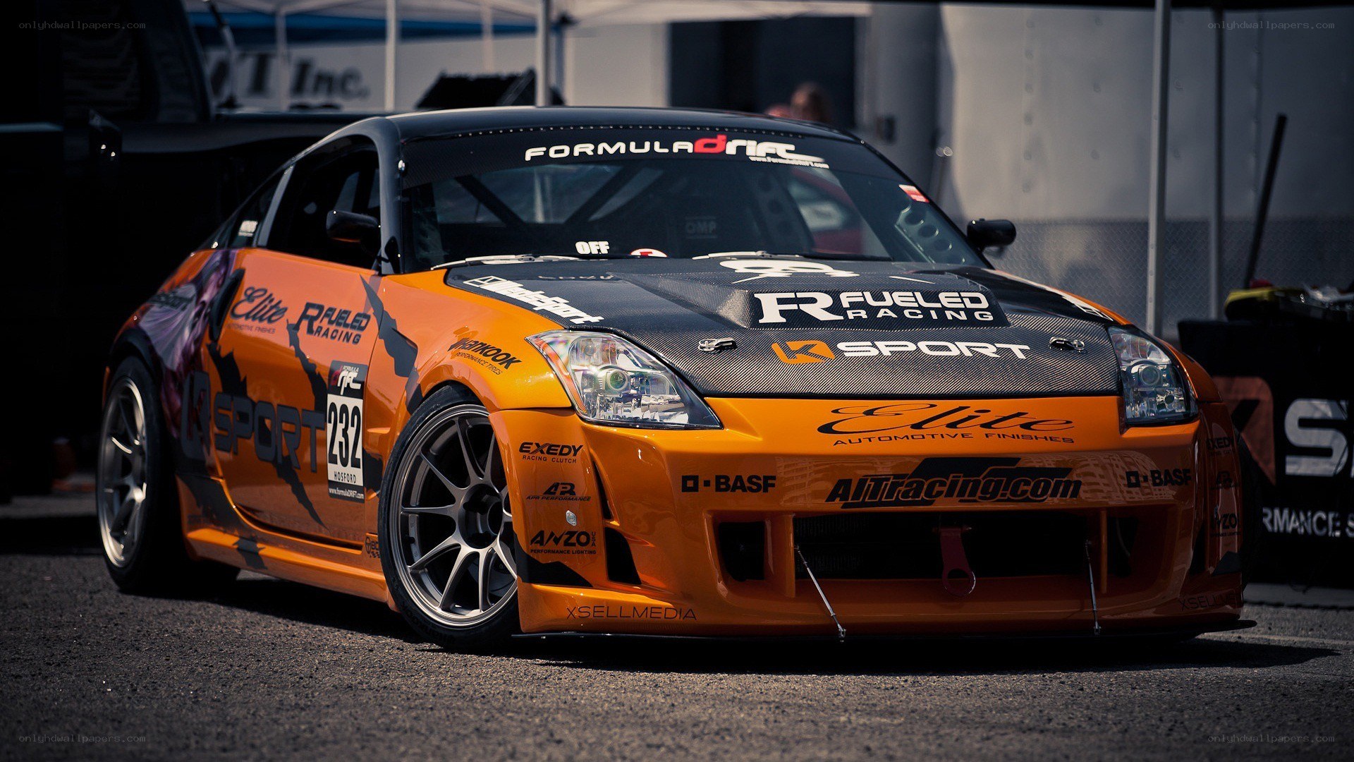 orange race car at a track