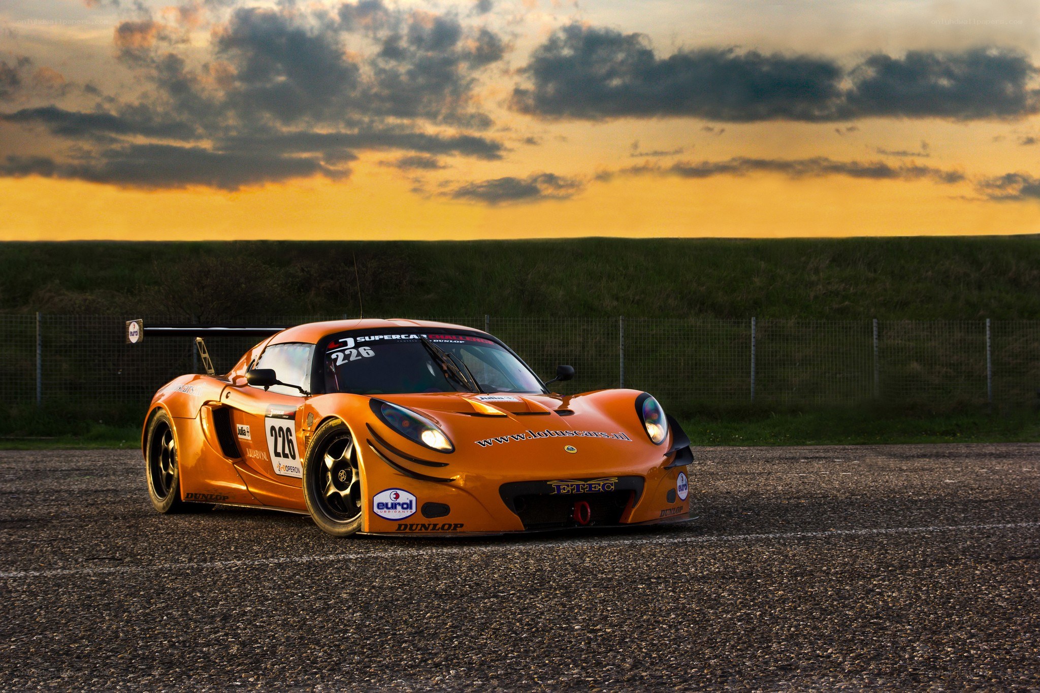 Orange race car at sunset