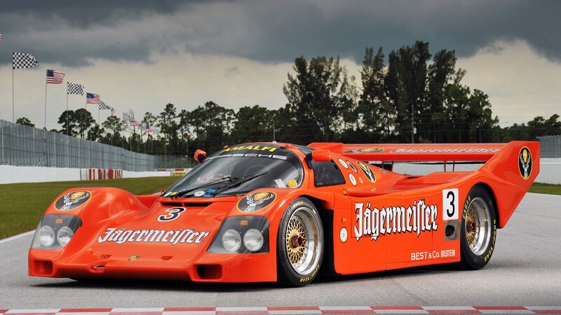 Orange Race Car — Dramatic, Afternoon, Photograph, Race Track, Flags