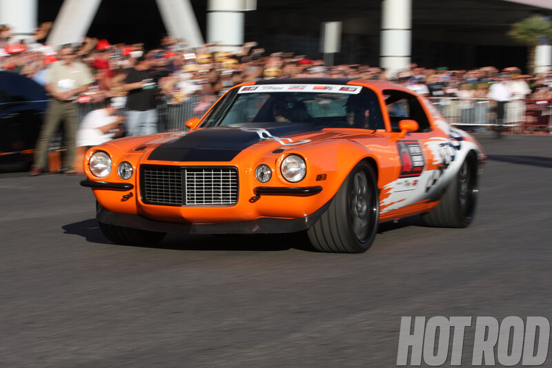 Orange Race Car — Dynamic, Afternoon, Photograph, Crowd, Spectators