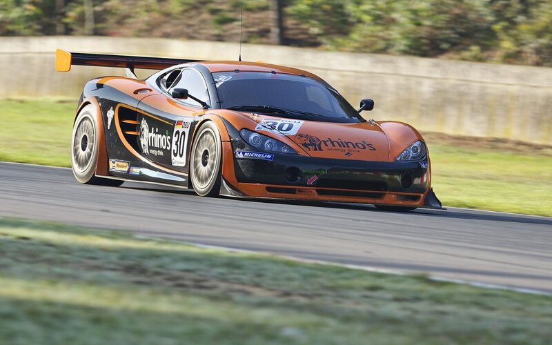 Orange Race Car — Dynamic, Afternoon, Photograph, Race Track, Grass, Tire