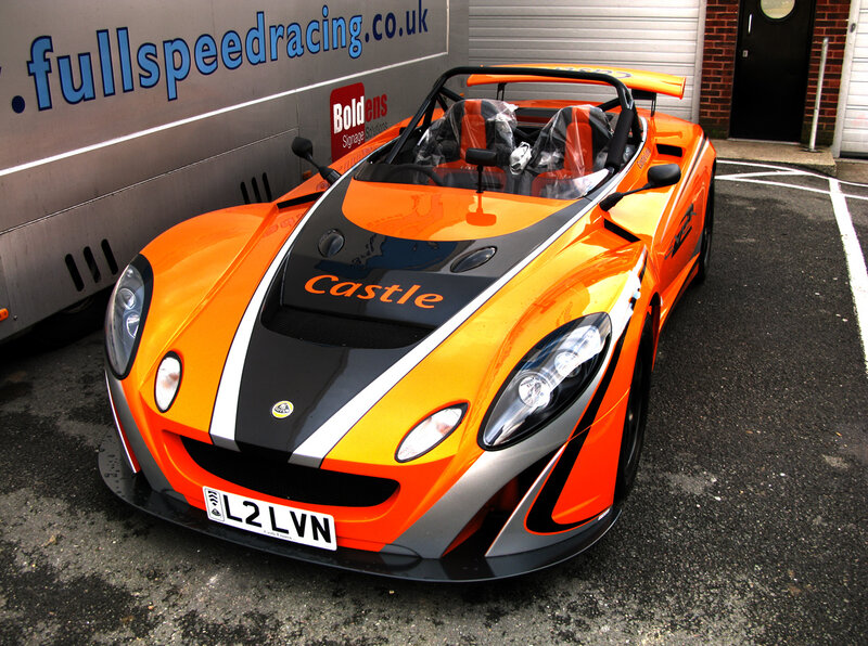 orange race car in parking lot
