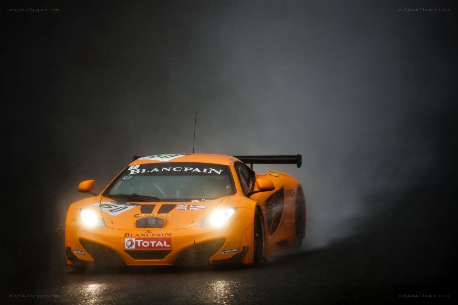 Orange race car in smoke