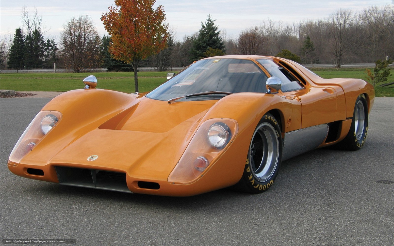 orange race car on asphalt