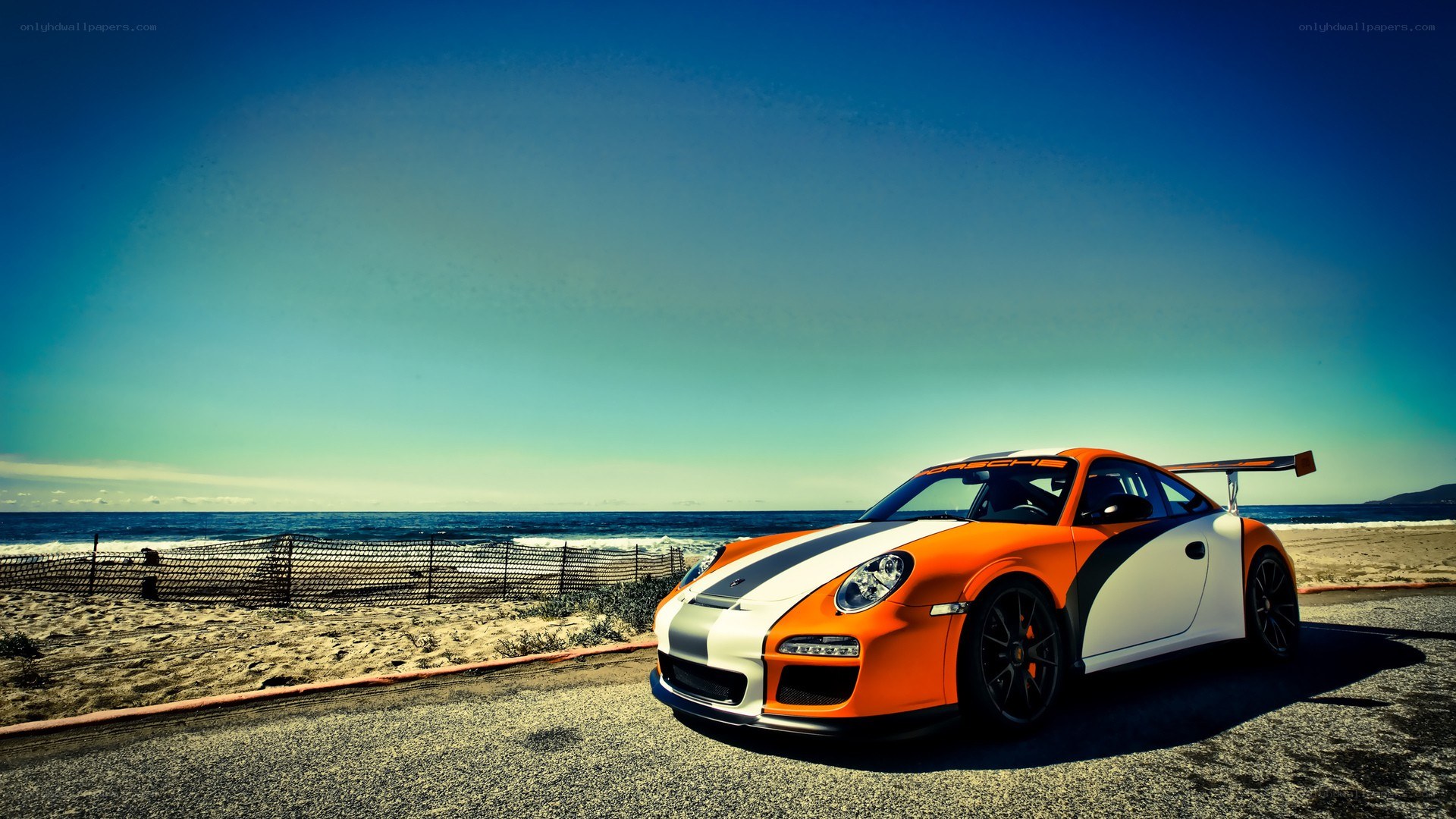 Orange race car on beach road